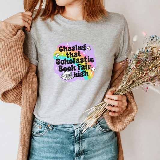 "Chasing that Scholastic Book Fair High" Teacher T-shirt - Teacher Care Crate - T-Shirt